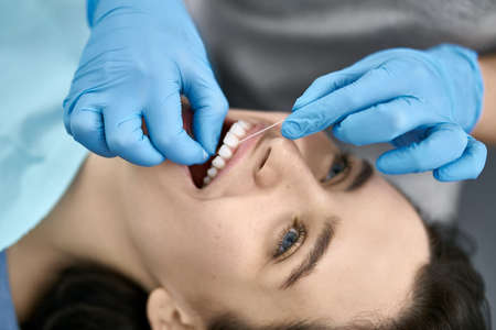 Pretty womans teeth cleaning in dental clinicの写真素材