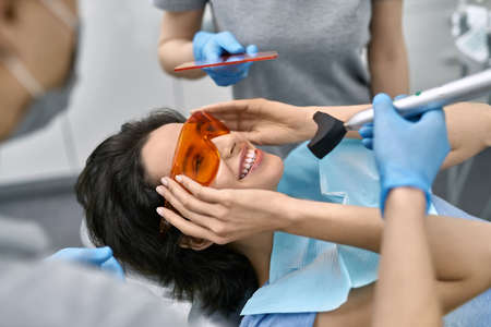 Pretty womans teeth treatment in dental clinicの写真素材