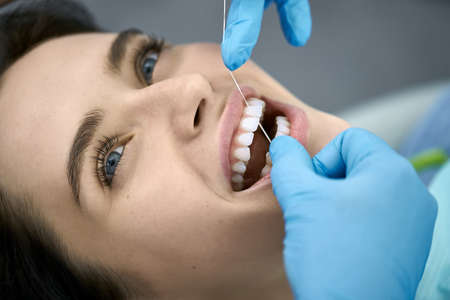 Pretty womans teeth cleaning in dental clinicの写真素材