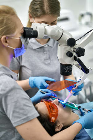 Pretty womans teeth treatment in dental clinicの写真素材