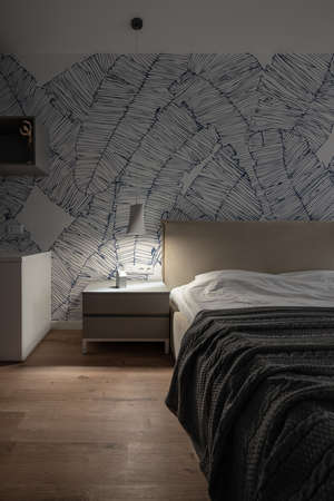 Stylish modern bedroom with white walls with patterns