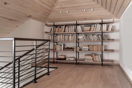 Light modern interior with sloping wooden ceilingの写真素材