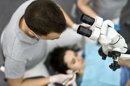 Pretty womans teeth treatment in dental clinicの写真素材