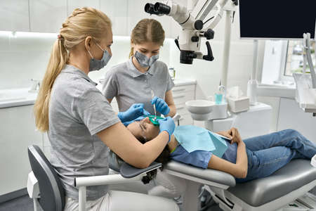 Pretty womans teeth cleaning in dental clinicの写真素材