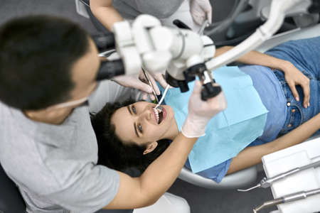 Pretty womans teeth treatment in dental clinicの写真素材