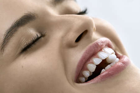 Closeup view at womans mouth with perfect teethの写真素材