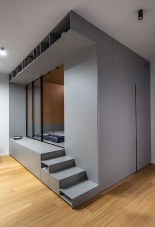 Stylish illuminated interior with podium with glass doorsの写真素材