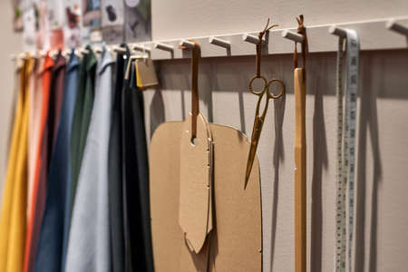 Closeup view at hanging fabric and sewing toolsの写真素材