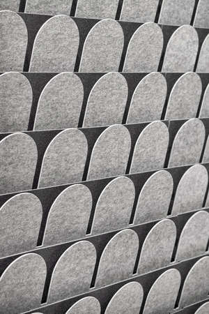 Rows of textured rounded gray pieces in the studio. Closeup photo with selective focus. Vertical.の写真素材