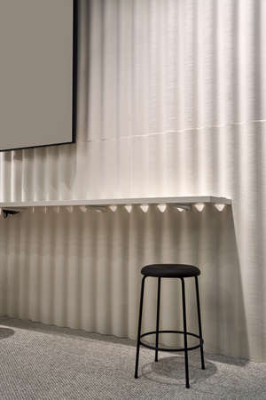 Luminous interior with waved light wall with a white shelf and a gray carpet on the floor. There is...