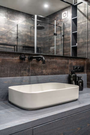 Interior of luminous modern bathroom with bronze wallsの写真素材