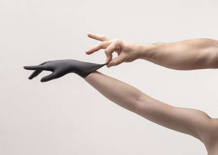 Female hand in a black silicone gloveの写真素材