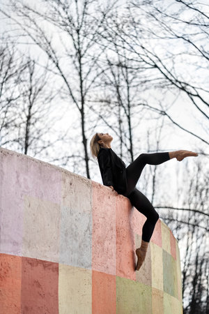 Blonde ballet dancer posing on colorful wallの写真素材
