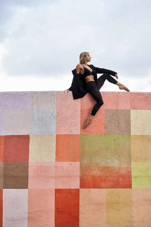 Blonde ballet dancer posing on colorful wallの写真素材