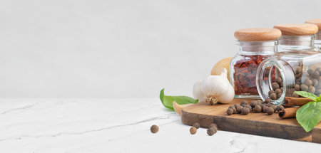 Gray background with spices for cooking on a wooden boardの写真素材