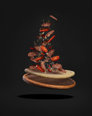 Pizza with salami on a wooden board with tomatoes and cheese levitating on a white background. Ingredients for pizza.の写真素材