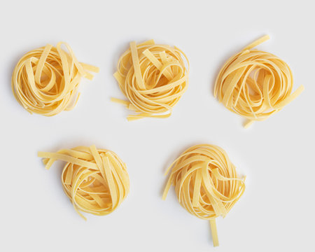 tagliatelli pasta on white backgroundの写真素材
