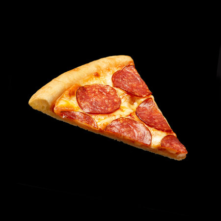 Slice of pepperoni pizza isolated on black backgroundの写真素材