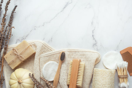 background for cosmetics. Natural eco cosmetics on a gray background. A wooden brush with a cotton towel and natural soap.の写真素材