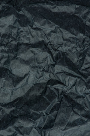 Macro texture of black crumpled paperの写真素材