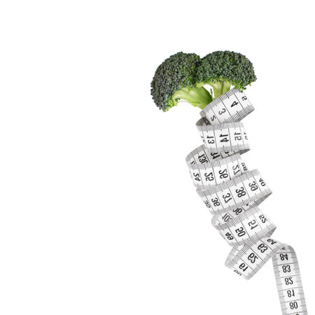 Green vegetables and a measuring tape on a white background.Healthy lifestyle concept. diet concept. weight loss concept.の写真素材