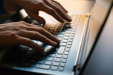 hands on laptop keyboard and touchpad