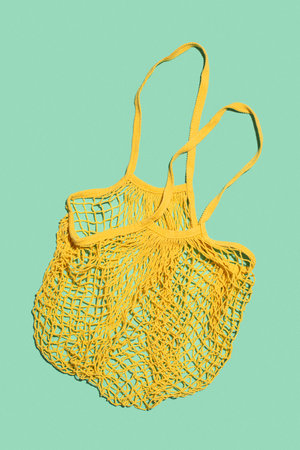 Yellow shopping bag on a salad background. Eco friendly.の写真素材