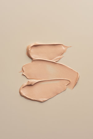 The texture of the foundation on a beige background
