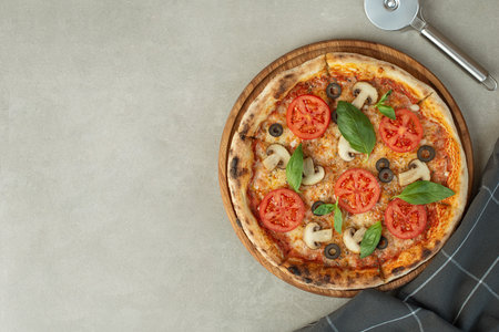 Pizza margherita with tomatoes and mushrooms on a gray background, top viewの写真素材