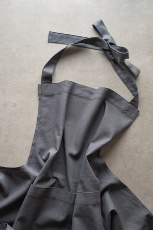 gray linen apron on a gray concrete backgroundの写真素材