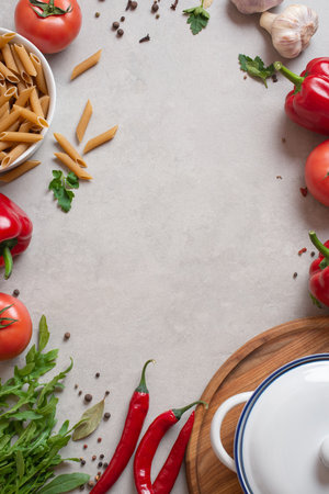 Culinary background with vegetables, saucepan and wooden board. Spices and herbs.の写真素材