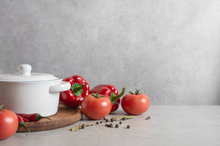 Culinary background with vegetables, saucepan and wooden board. Spices and herbs.の写真素材