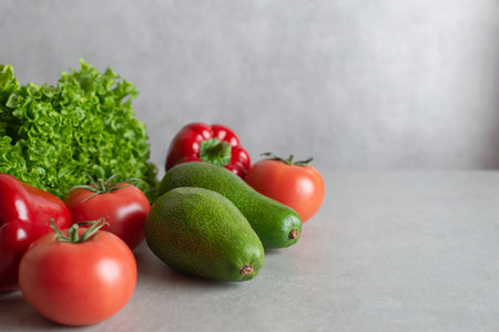 gray concrete background with vegetables and lettuce. Culinary background, horizontal.の写真素材