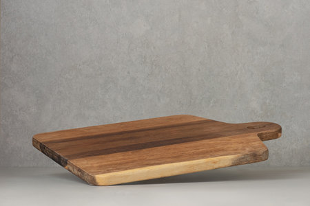 Cooking board falling on the table. Levitation, flying wooden cooking board.の写真素材