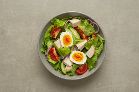vegetable salad with an egg on a gray backgroundの写真素材