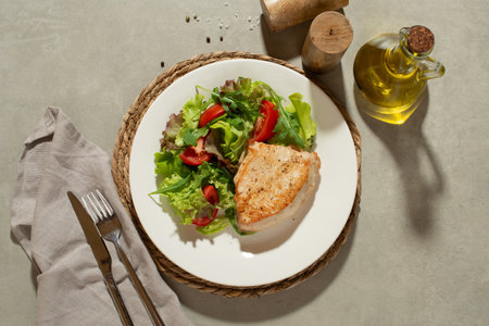 Salad with vegetables and chicken on a gray backgroundの写真素材