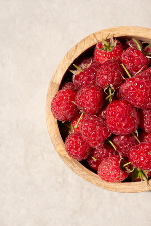 Raspberries in a wooden cup on a gray background. Macroの写真素材