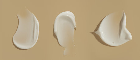 strokes of white cream on a beige background, macro textureの写真素材