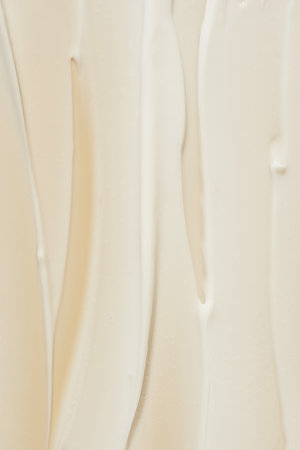 strokes of white cream on a beige background, macro textureの写真素材