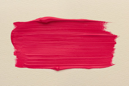 Macro texture of strokes of red acrylic glossy paint on white paper