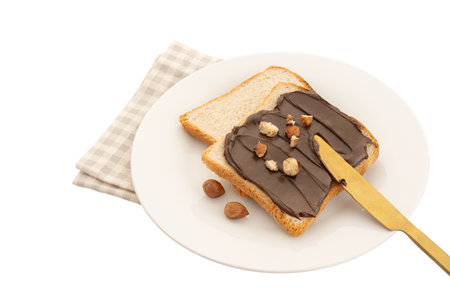 White wheat bread toasts with nut chocolate spread on a white plate isolated on white backgroundの写真素材