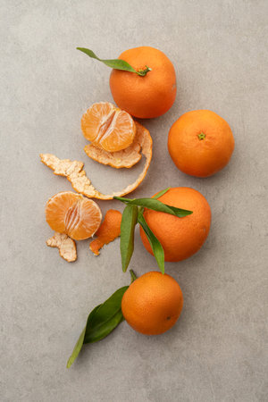 Gray background with tangerines with leavesの写真素材