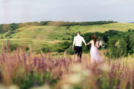 bride and groom on a wedding walk in natureの写真素材