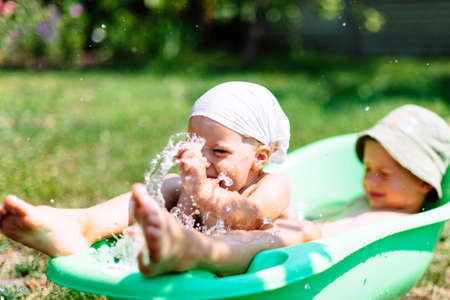 brother and sister with blue eyes play together in the countryside in nature in summerの写真素材