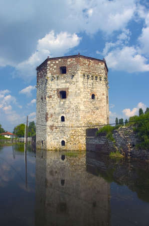 very old tower on the waterの写真素材