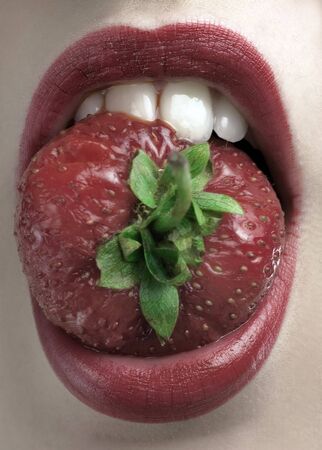 red lips and mouth with red strawberryの写真素材