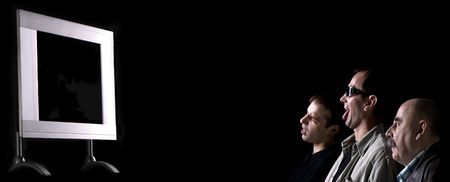 three men are looking plasma screenの写真素材