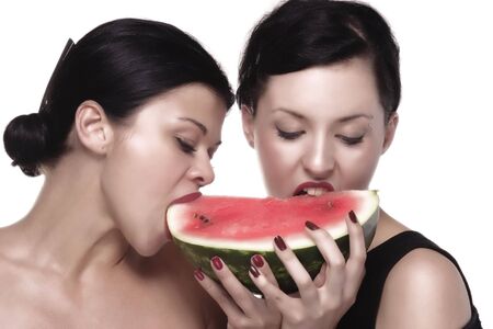 girls are eating melonの写真素材