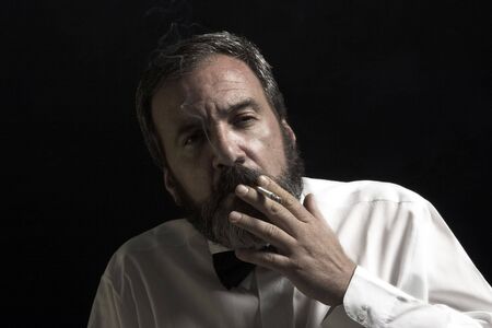 thoughtful gentleman is smokingの写真素材