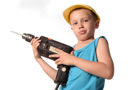 a boy is drilling the wallの写真素材